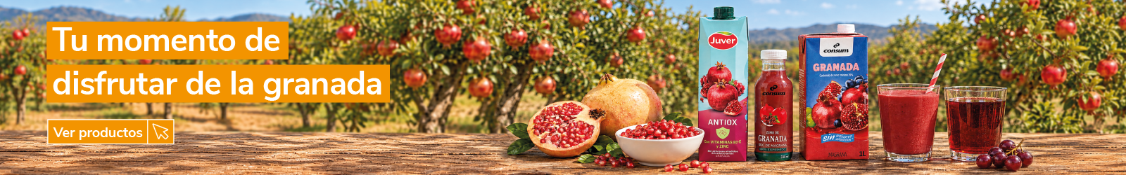 Banner de productos de granada con el mensaje "Tu momento de disfrutar de la granada". Granada fresca abierta, granos de granada, zumos y bebidas de granada de las marcas Juver y Consum sobre una mesa de madera, con un campo de granados al fondo. Botón "Ver productos".